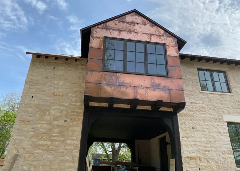 Copper metal panel facade on a stone building for Metal Roof Coating in Greenwood Village